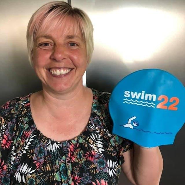 Kirsten smiling with her Swim22 cap 