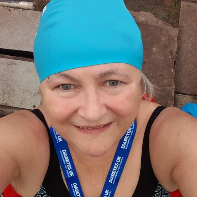 Annie wearing her Swim22 hat and Swim22 medal