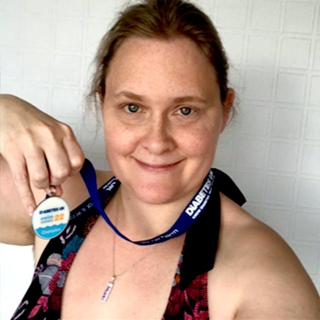 Amanda smiling with her Swim22 medal after swimming Swim22 for Diabetes UK